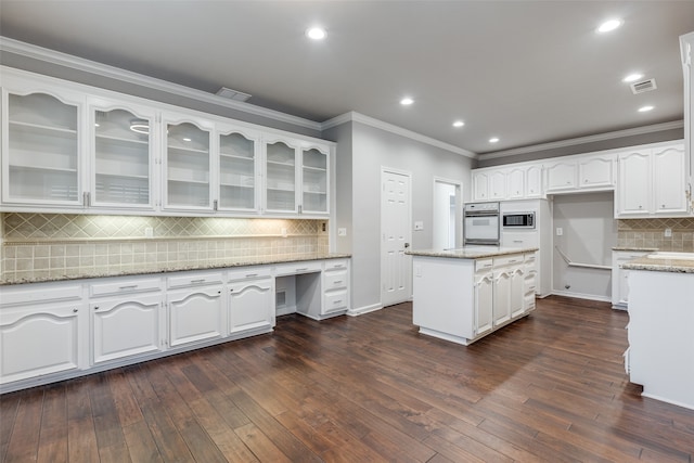 kitchen with dark hardwood / wood-style flooring, white cabinetry, light stone counters, and white oven