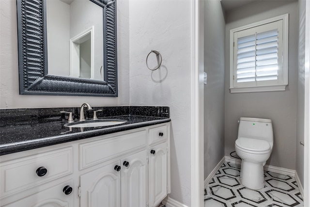 bathroom with tile patterned floors, vanity, and toilet