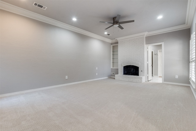 unfurnished living room featuring ceiling fan, light colored carpet, ornamental molding, and a fireplace