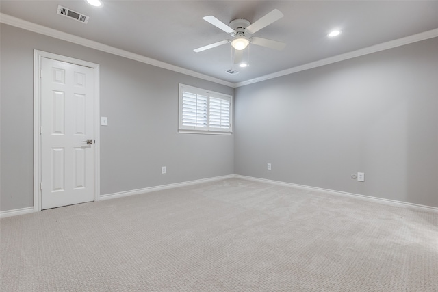 empty room with ceiling fan, ornamental molding, and light carpet