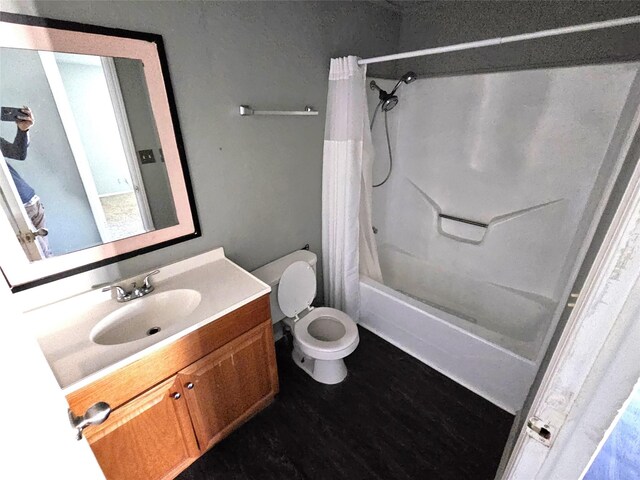 full bathroom featuring shower / tub combo, vanity, hardwood / wood-style flooring, and toilet