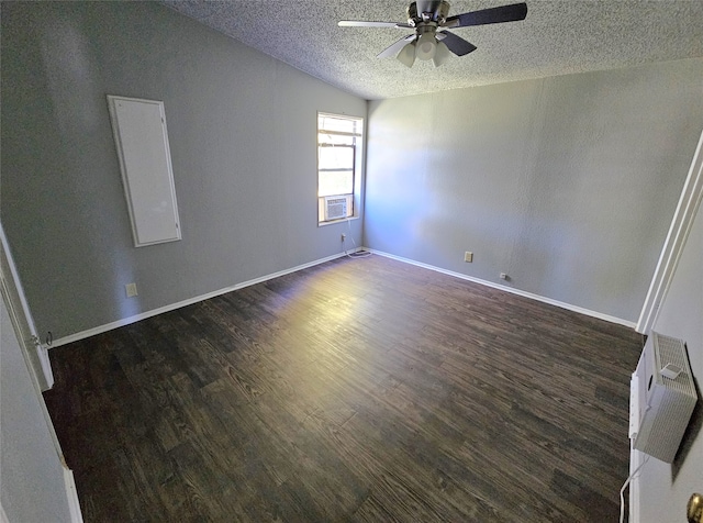 unfurnished room featuring lofted ceiling, dark hardwood / wood-style flooring, ceiling fan, and a textured ceiling