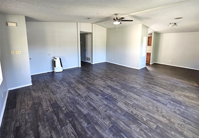 empty room featuring a textured ceiling, ceiling fan, and dark wood-type flooring