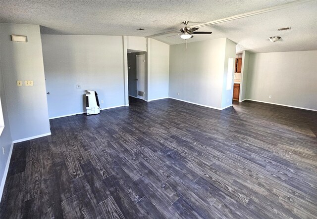 empty room featuring a textured ceiling, ceiling fan, and dark wood-type flooring