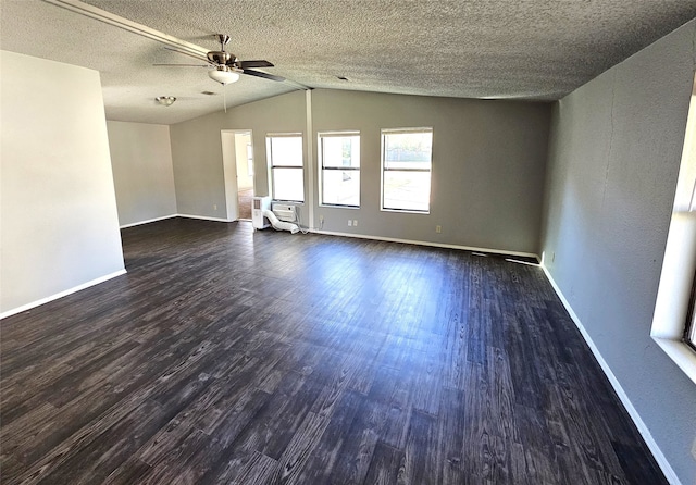 empty room featuring ceiling fan, dark hardwood / wood-style flooring, lofted ceiling, and a textured ceiling