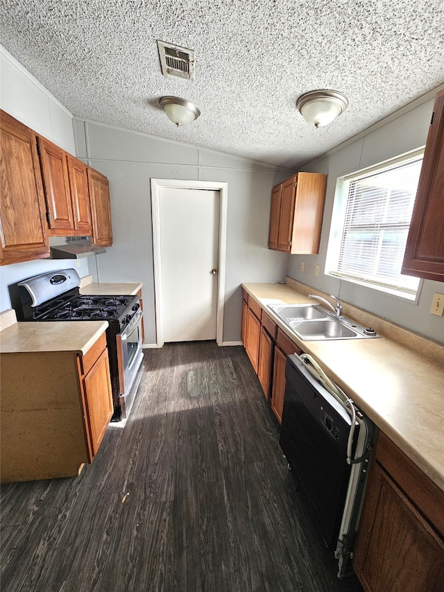 kitchen with a textured ceiling, black dishwasher, dark hardwood / wood-style floors, and stainless steel range with gas cooktop