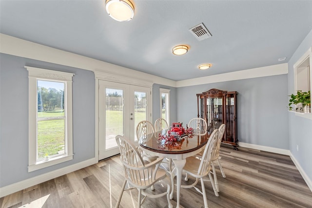 dining room featuring french doors and hardwood / wood-style flooring