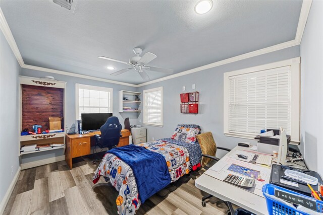 bedroom with ceiling fan, crown molding, a textured ceiling, and light wood-type flooring