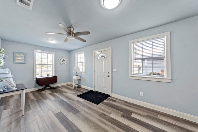 foyer entrance featuring hardwood / wood-style flooring, ceiling fan, and a textured ceiling