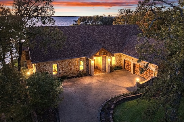 view of front facade featuring a water view and a garage