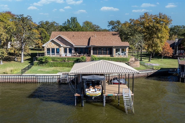 dock area with a lawn and a water view