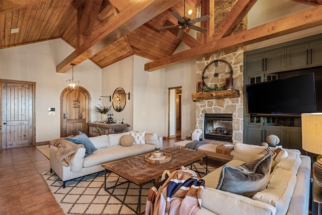 tiled living room with a fireplace, high vaulted ceiling, ceiling fan, and wood ceiling