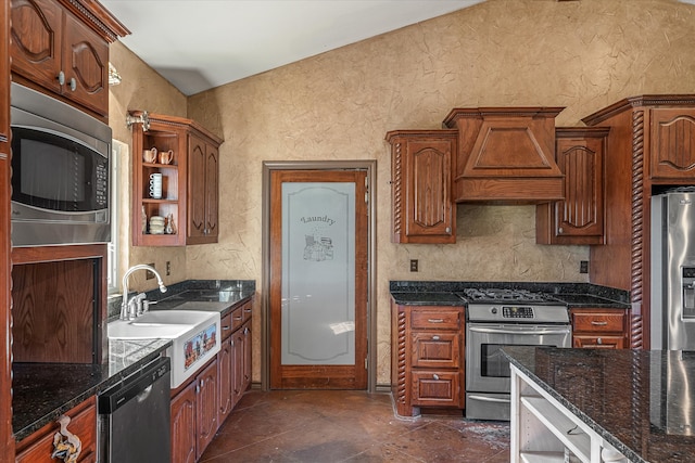 kitchen with premium range hood, dark stone countertops, sink, and stainless steel appliances