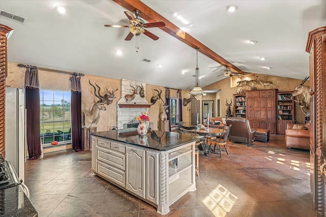 kitchen with a center island, lofted ceiling with beams, ceiling fan, and hanging light fixtures