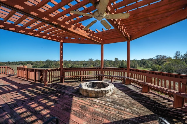 wooden terrace with a pergola, ceiling fan, and a fire pit