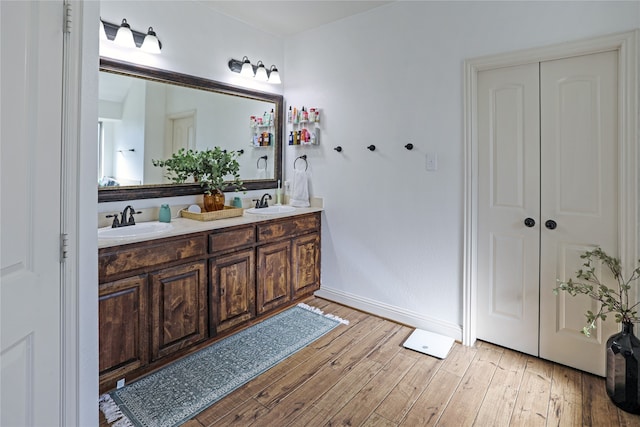 bathroom with hardwood / wood-style floors and vanity