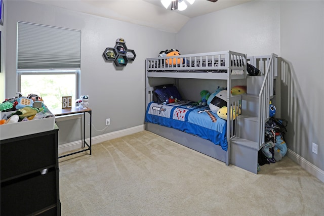 carpeted bedroom with vaulted ceiling and ceiling fan