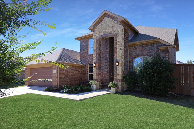 view of front of property featuring a front yard and a garage