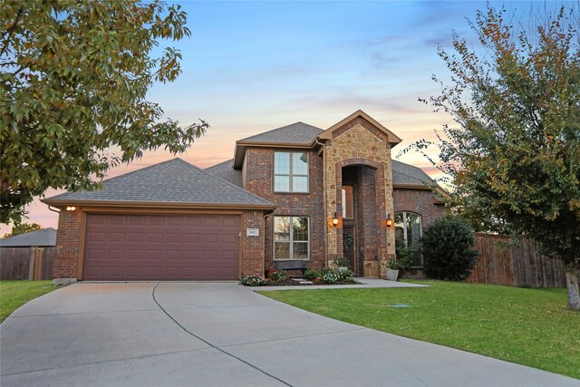 view of front of house with a lawn and a garage