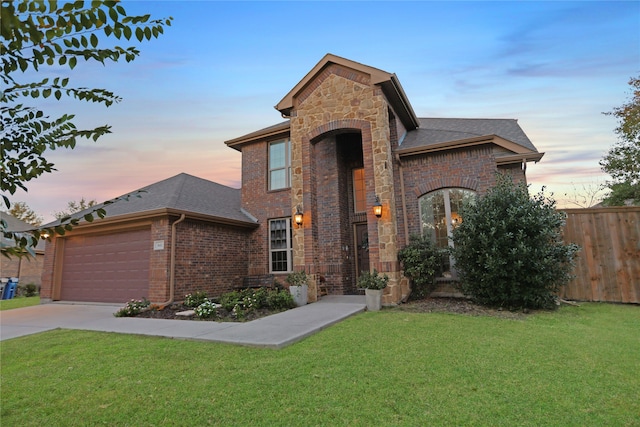 view of front of property featuring a yard and a garage