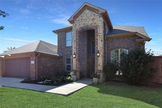 view of front property featuring a front yard and a garage