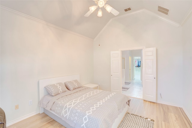 bedroom with ceiling fan, crown molding, high vaulted ceiling, and light wood-type flooring