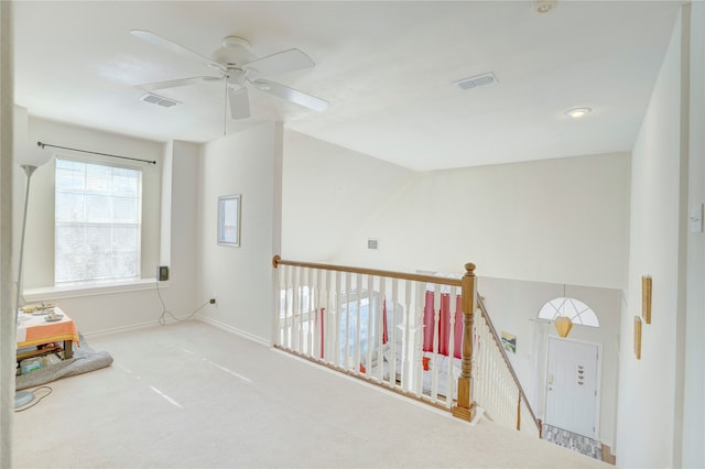 carpeted spare room with ceiling fan