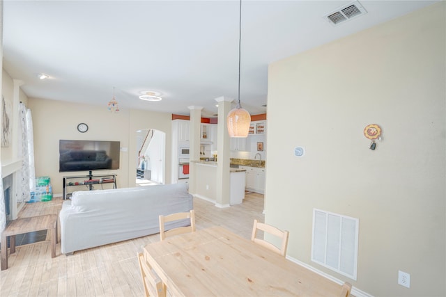 living room featuring light hardwood / wood-style floors and sink