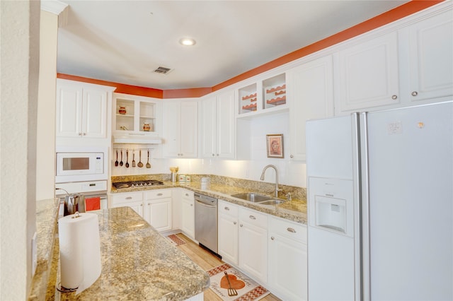 kitchen featuring light stone counters, sink, white cabinetry, and stainless steel appliances