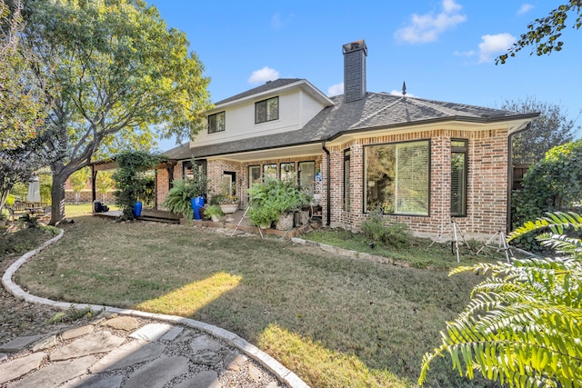 rear view of house with a lawn