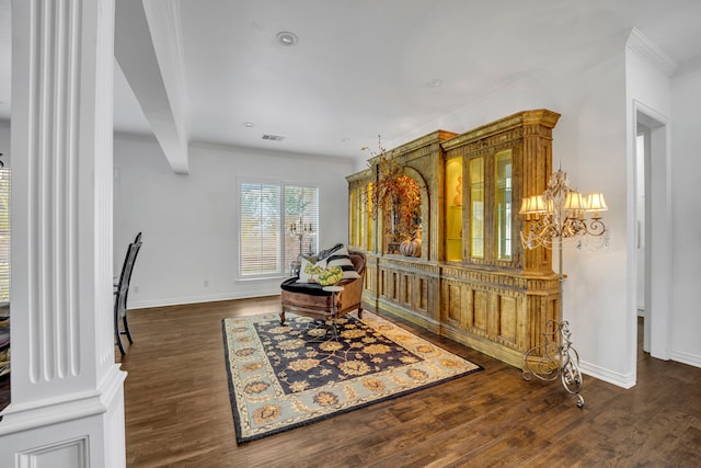 sitting room with dark hardwood / wood-style floors, an inviting chandelier, and crown molding