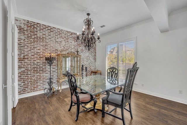 dining room with ornamental molding, a notable chandelier, dark wood-type flooring, and brick wall