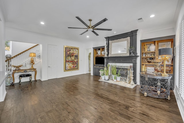 2405 Deer Run Ct, Heath, TX 75032 - living room featuring ceiling fan, stairway, a fireplace, wood finished floors, and crown molding