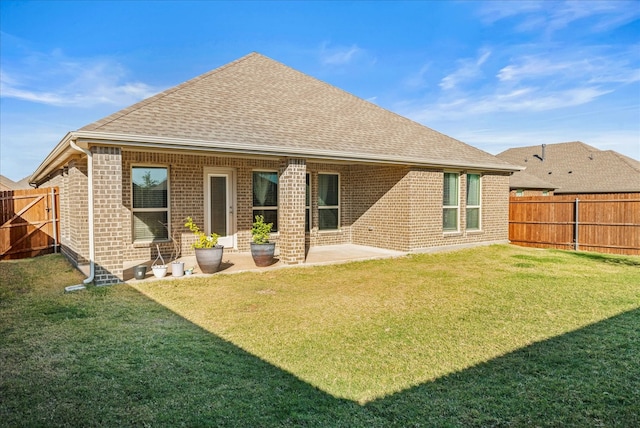 back of house featuring a yard and a patio