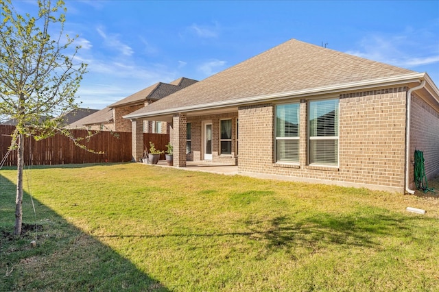 rear view of property with a patio area and a lawn