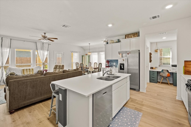 kitchen featuring a wealth of natural light, a center island with sink, stainless steel appliances, and sink