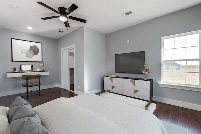 bedroom with ceiling fan and dark wood-type flooring