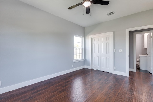 unfurnished bedroom featuring a closet, ceiling fan, and dark hardwood / wood-style flooring