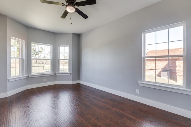 empty room featuring ceiling fan and dark hardwood / wood-style flooring