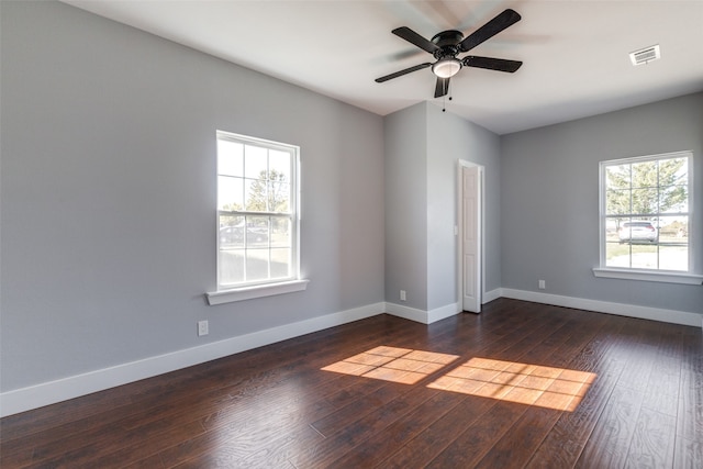 unfurnished room featuring ceiling fan, plenty of natural light, and dark hardwood / wood-style floors