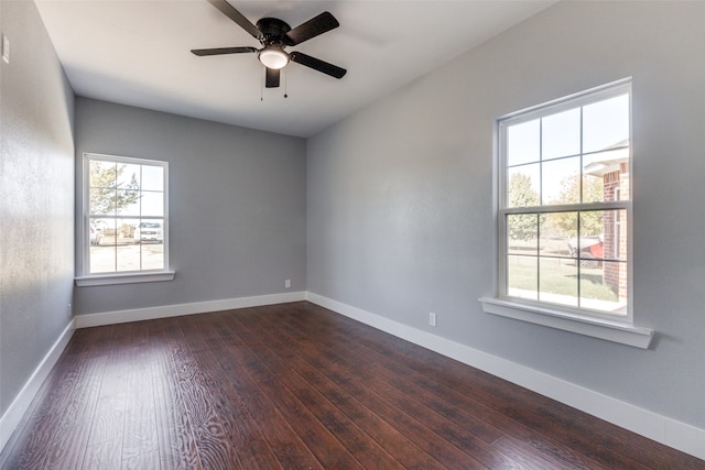 unfurnished room with ceiling fan and dark wood-type flooring