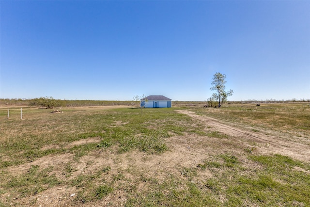 view of yard featuring an outbuilding and a rural view