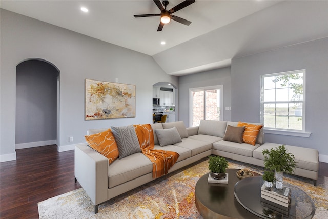 living room with dark hardwood / wood-style floors, ceiling fan, and lofted ceiling