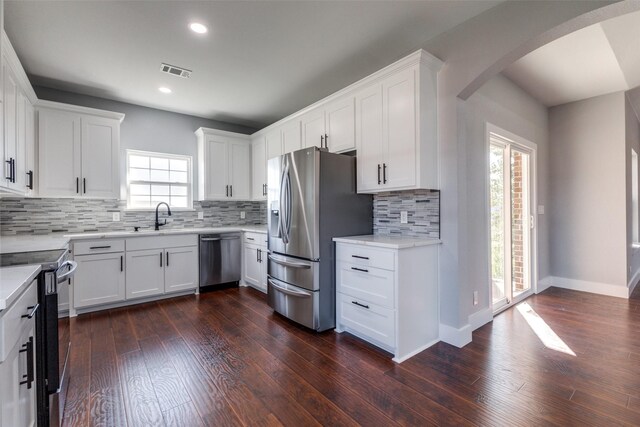 kitchen featuring white cabinets, dark wood-type flooring, and appliances with stainless steel finishes