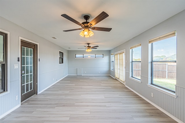 unfurnished sunroom featuring plenty of natural light and ceiling fan