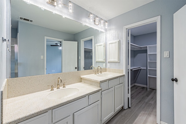 bathroom featuring ceiling fan, wood-type flooring, and vanity