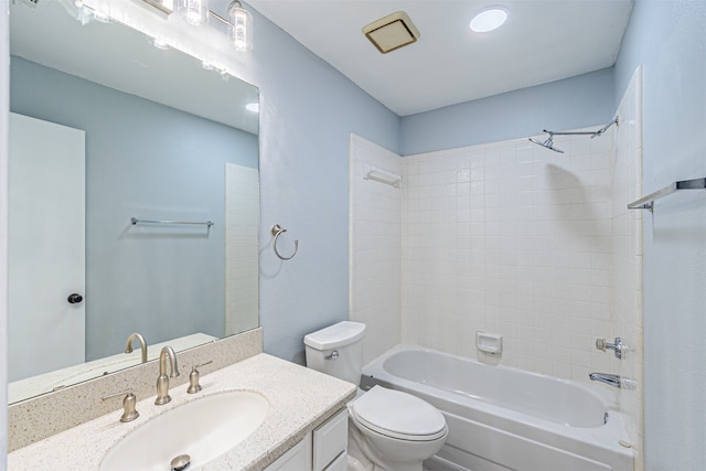 full bathroom with vanity, tiled shower / bath combo, and toilet