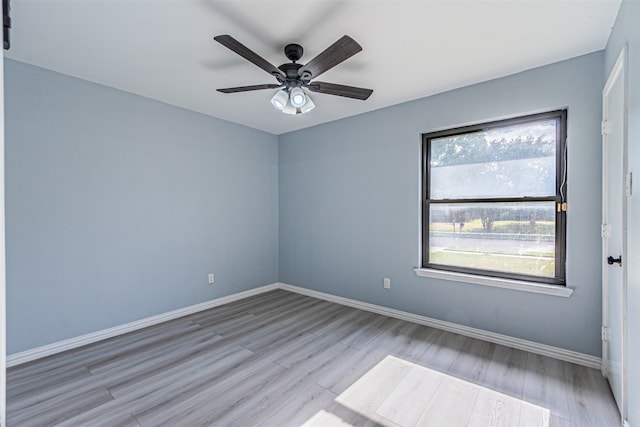 empty room with ceiling fan and light wood-type flooring