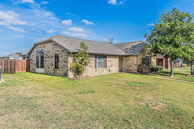 ranch-style home featuring a front yard