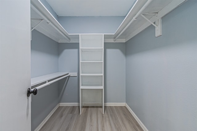 spacious closet with light hardwood / wood-style floors